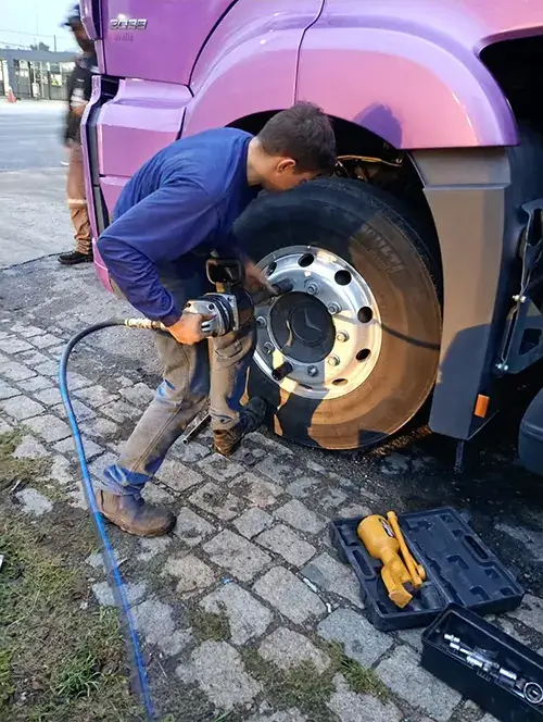 Profissional reparando uma câmara de ar durante atendimento móvel